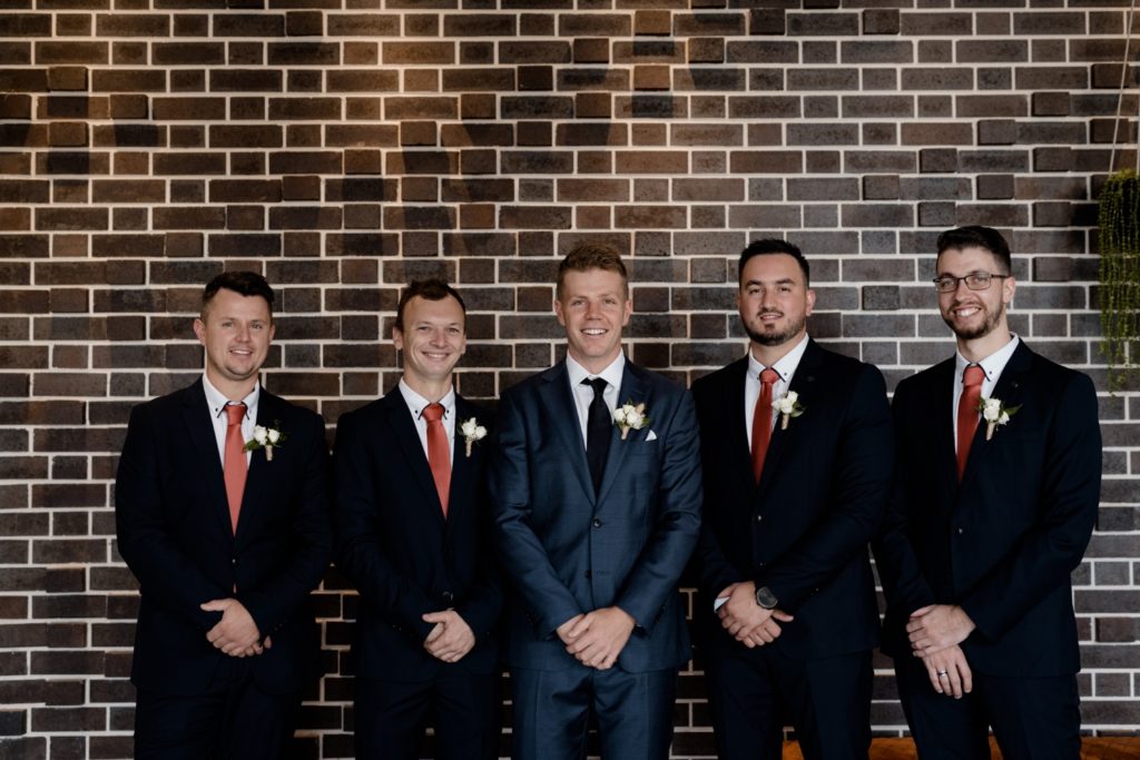 groom and groomsmen posing before the wedding